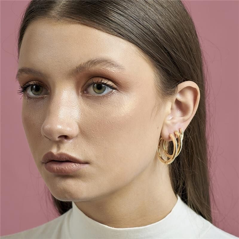 Gold-plated hoop earring with a single row of white zirconia stones.